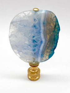 Blue agate mineral lamp finial with natural banding and translucent crystal patterns on a knurled brass fitting