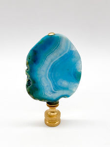 Blue agate mineral lamp finial with natural banding and translucent crystal patterns on a knurled brass fitting