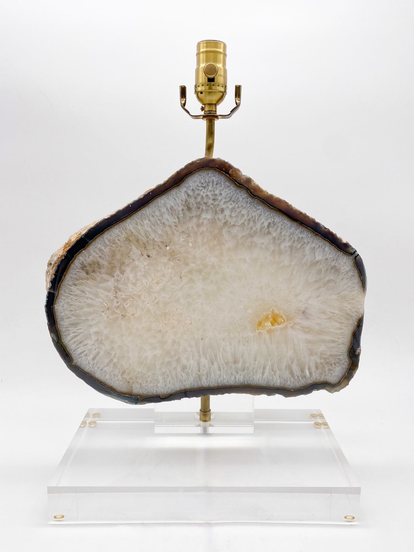 A Brazilian Agate slice mounted on a acrylic stand as a lamp.