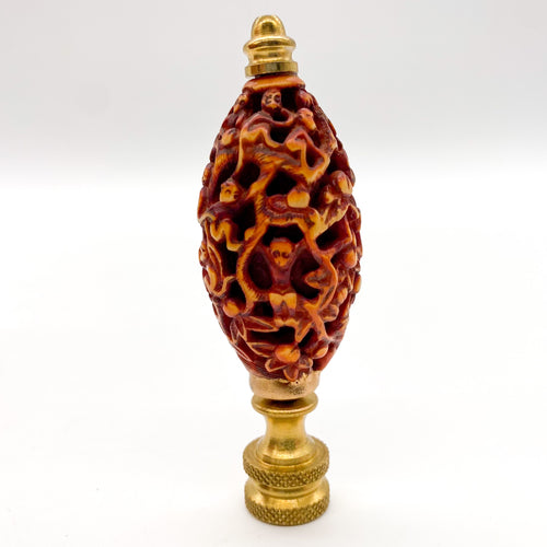 brown carved root wood finial depicting monkeys in a tree
