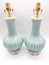 Load image into Gallery viewer, Pair of light celadon turquoise striped lamps with gold accents on graduated stacked acrylic bases