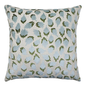 Decorative pillow with blue and green leaf pattern on a white background