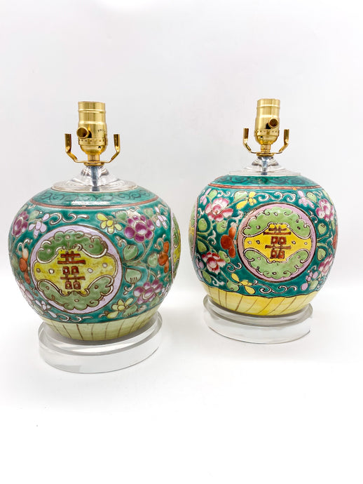 Two ceramic table lamps with floral designs and gold accents on a white background