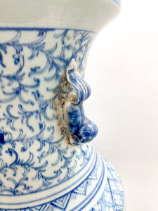 large blue and white chinese ceramic bell jar top urn with fou lion handles greek key and other hand painted design elements and patterns
