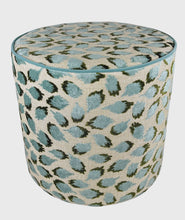 Load image into Gallery viewer, blue and green abstract pattern on off-white beige linen like slip cover cylindrical ottoman with teal blue piping