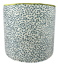 Load image into Gallery viewer, blue speckled abstract pattern on white linen like slip cover cylindrical ottoman with lime green piping