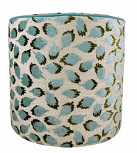 Load image into Gallery viewer, blue and green abstract pattern on off-white beige linen like slip cover cylindrical ottoman with teal blue piping
