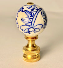 Load image into Gallery viewer, blue and white floral porcelain lamp finial, brass lamp finial with ceramic ball top, chinoiserie style lamp finial with hand painted flower design, decorative blue white finial for table or floor lamps, classic porcelain and brass lamp finial with floral pattern, traditional lamp finial with blue floral motif and gold base, ceramic ball finial with blue flower detail and brass hardware, elegant blue and white lamp finial fits standard lamp harp331