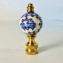 Load image into Gallery viewer, blue and white floral porcelain lamp finial, brass lamp finial with ceramic ball top, chinoiserie style lamp finial with hand painted flower design, decorative blue white finial for table or floor lamps, classic porcelain and brass lamp finial with floral pattern, traditional lamp finial with blue floral motif and gold base, ceramic ball finial with blue flower detail and brass hardware, elegant blue and white lamp finial fits standard lamp harp