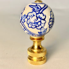 Load image into Gallery viewer, blue and white floral porcelain lamp finial, brass lamp finial with ceramic ball top, chinoiserie style lamp finial with hand painted flower design, decorative blue white finial for table or floor lamps, classic porcelain and brass lamp finial with floral pattern, traditional lamp finial with blue floral motif and gold base, ceramic ball finial with blue flower detail and brass hardware, elegant blue and white lamp finial fits standard lamp harp